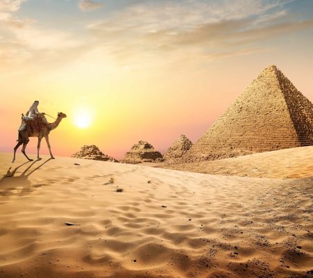 Egyptian pyramids in the desert at sunset